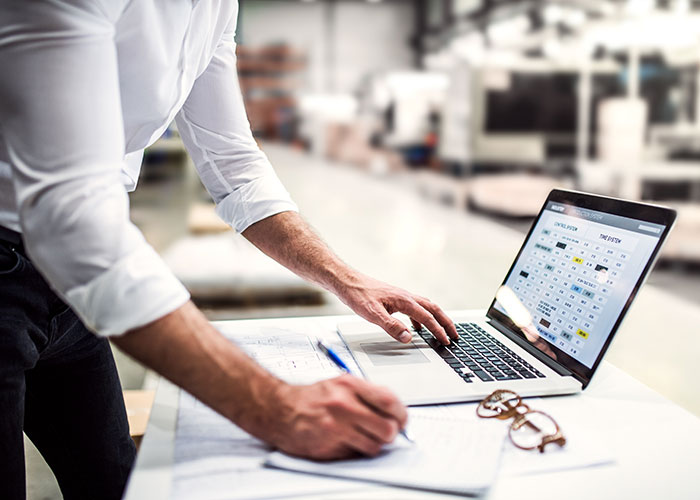 Facilities manager checking air conditioning audit results